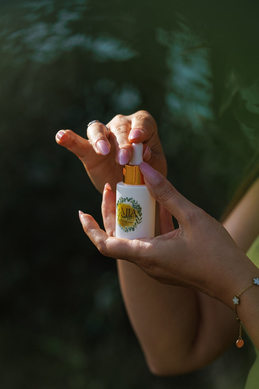Hands holding the Mia Noore Balanced Harmony natural face oil bottle