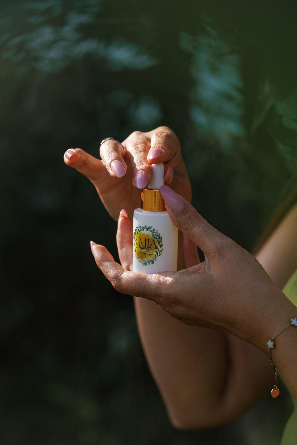 Hands holding the Mia Noore Balanced Harmony natural face oil bottle