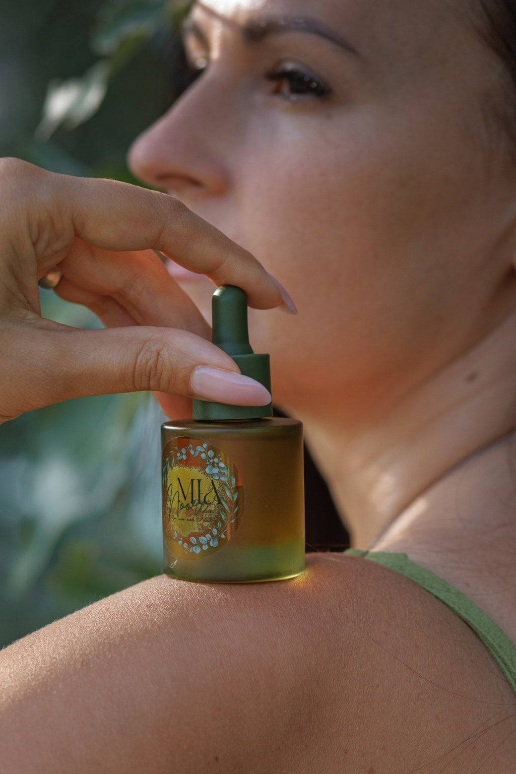 Mia Noore Radiant Glow natural face oil held against the skin