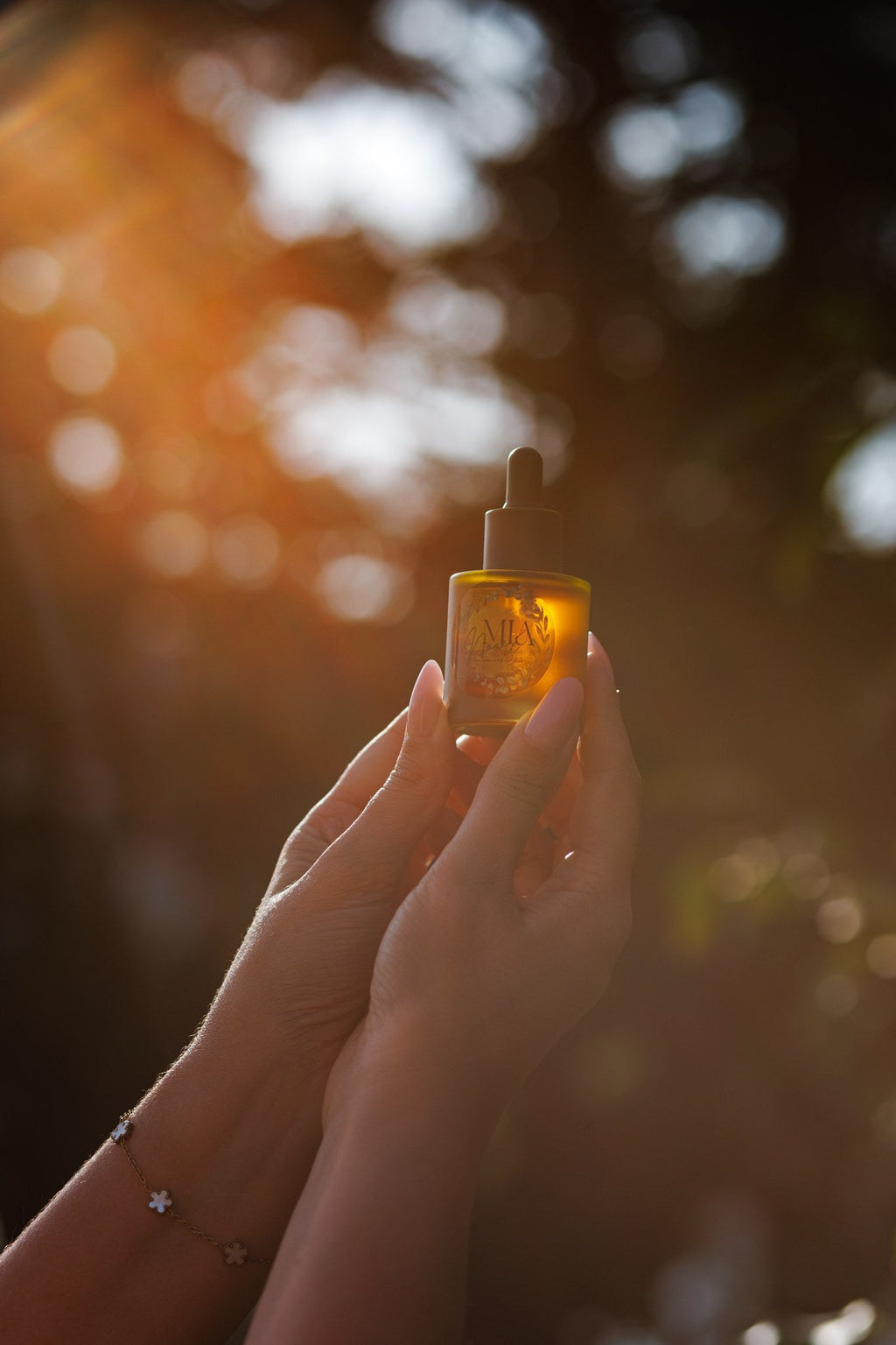 Mia Noore Radiant Glow face oil glowing in golden sunset light