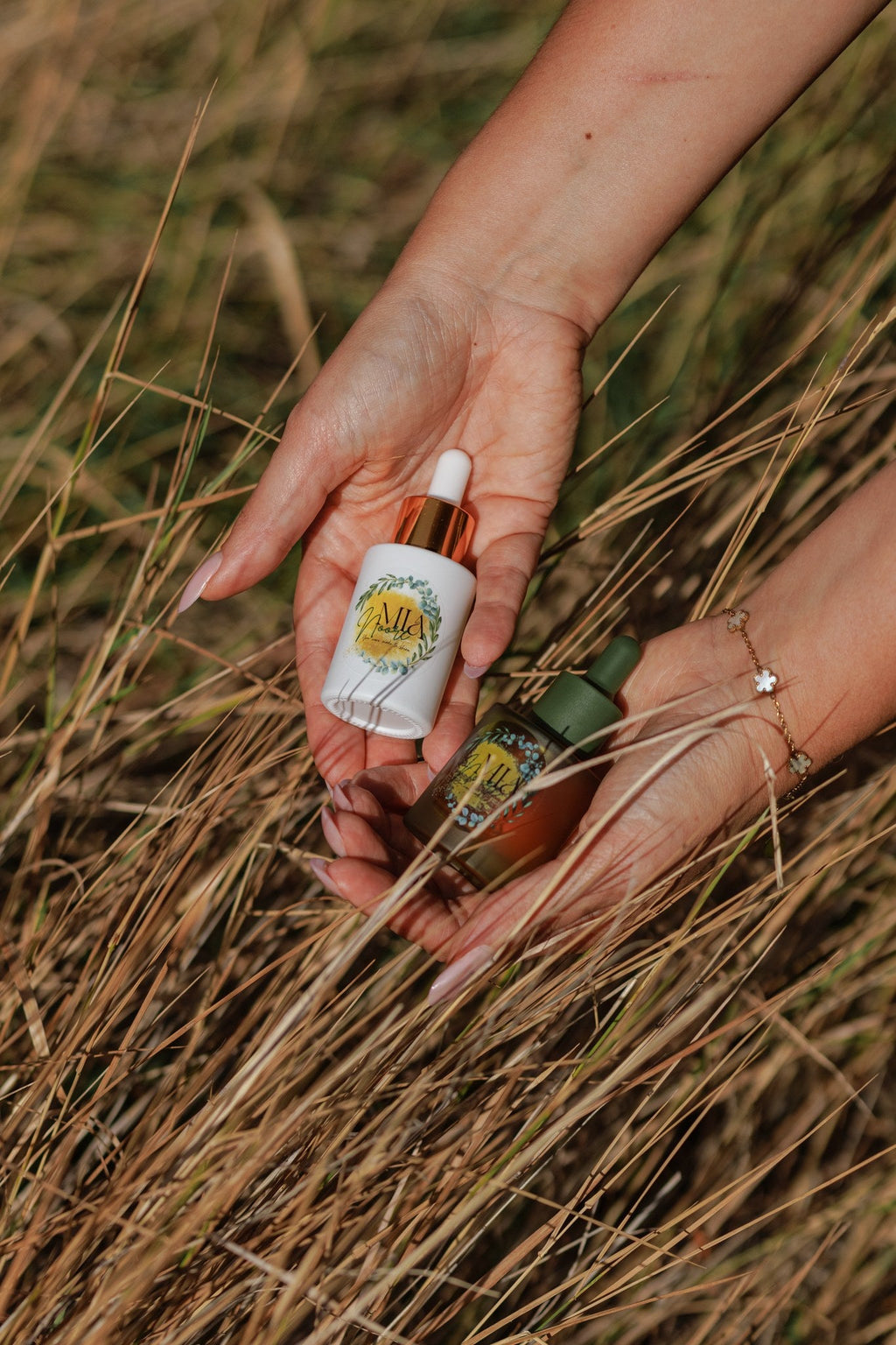 Hands holding the Mia Noore Balanced Harmony and Radiant Glow full-size face oils