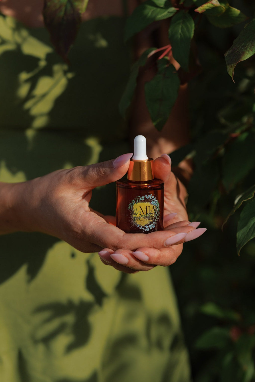 Mia Noore Timeless anti-aging face oil resting in an open palm, showing the 30 mL bottle size